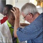 mickey estes praying in Liberia West Africa at World Harvest Church Liberia